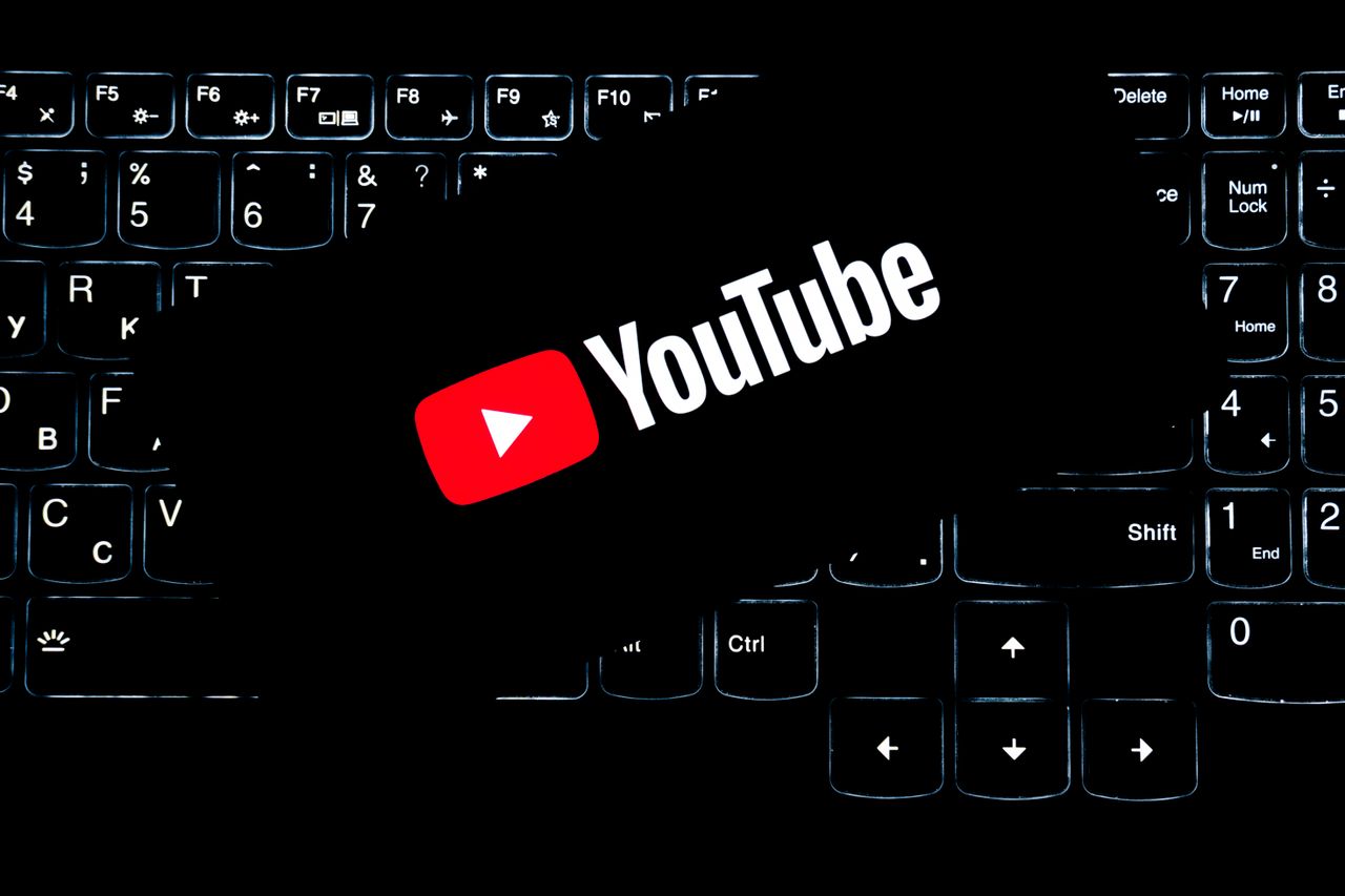 why-choose-us YouTube logo shown on a backlit keyboard, symbolizing digital media and online content creation.